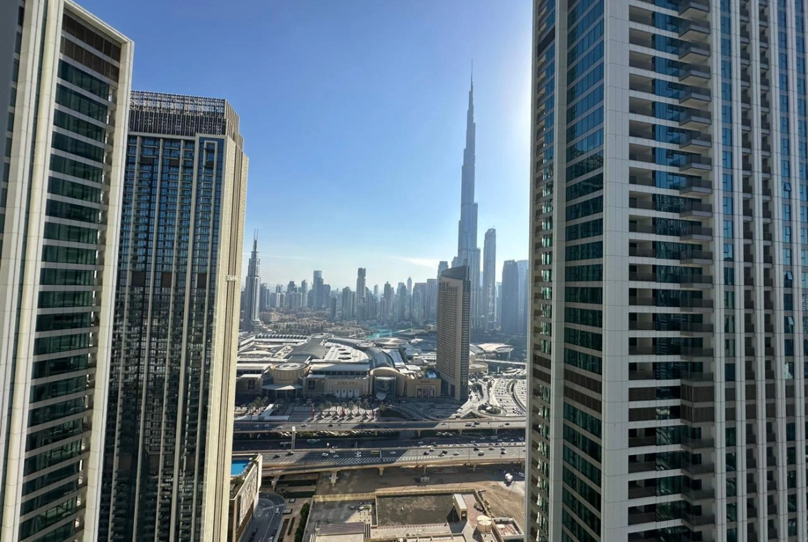 Exterior view of Downtown Views II, a modern apartment complex in Dubai, featuring sleek architectural design with glass facades, and an interior shot of a three-bedroom apartment with contemporary decor, large windows, and luxurious finishes.