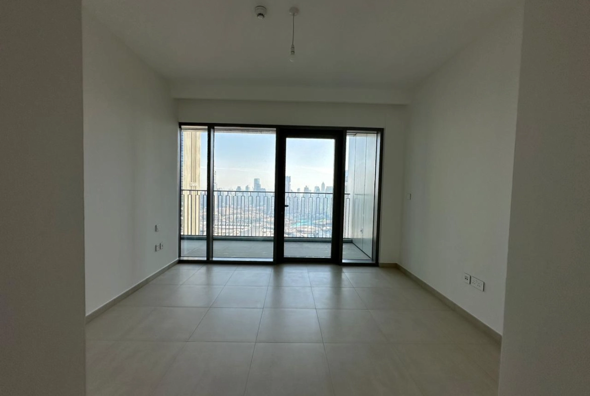 Exterior view of Downtown Views II, a modern apartment complex in Dubai, featuring sleek architectural design with glass facades, and an interior shot of a three-bedroom apartment with contemporary decor, large windows, and luxurious finishes.