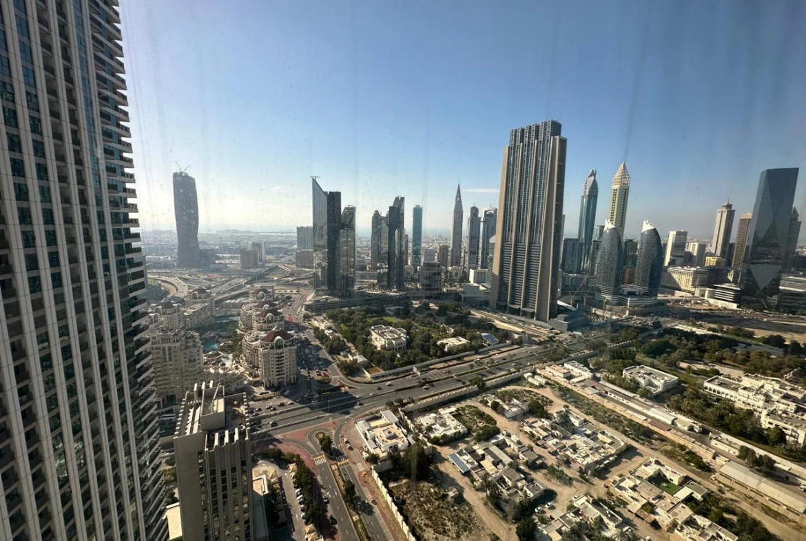 Exterior view of Downtown Views II, a modern apartment complex in Dubai, featuring sleek architectural design with glass facades, and an interior shot of a three-bedroom apartment with contemporary decor, large windows, and luxurious finishes.