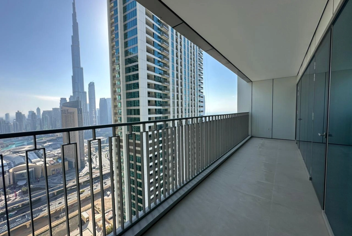 Exterior view of Downtown Views II, a modern apartment complex in Dubai, featuring sleek architectural design with glass facades, and an interior shot of a three-bedroom apartment with contemporary decor, large windows, and luxurious finishes.