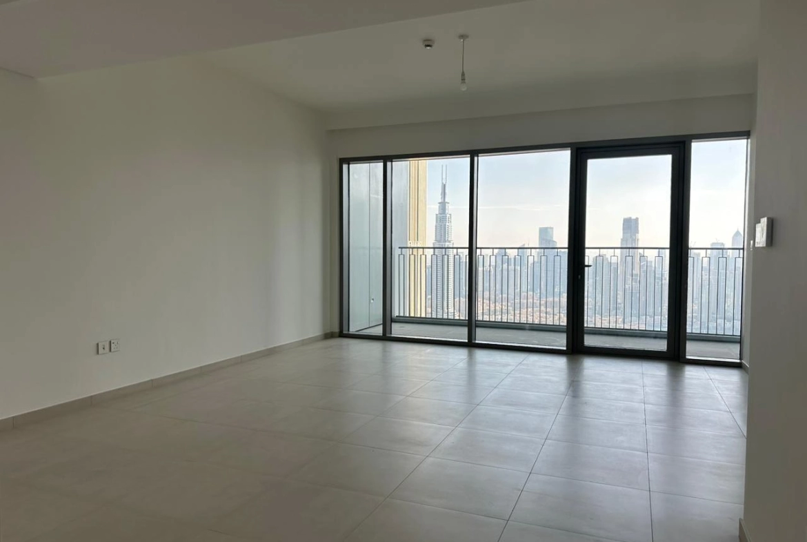 Exterior view of Downtown Views II, a modern apartment complex in Dubai, featuring sleek architectural design with glass facades, and an interior shot of a three-bedroom apartment with contemporary decor, large windows, and luxurious finishes.