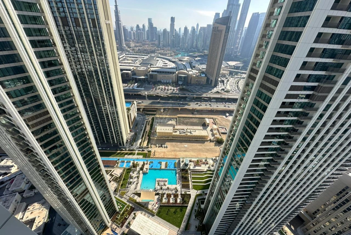 Exterior view of Downtown Views II, a modern apartment complex in Dubai, featuring sleek architectural design with glass facades, and an interior shot of a three-bedroom apartment with contemporary decor, large windows, and luxurious finishes.