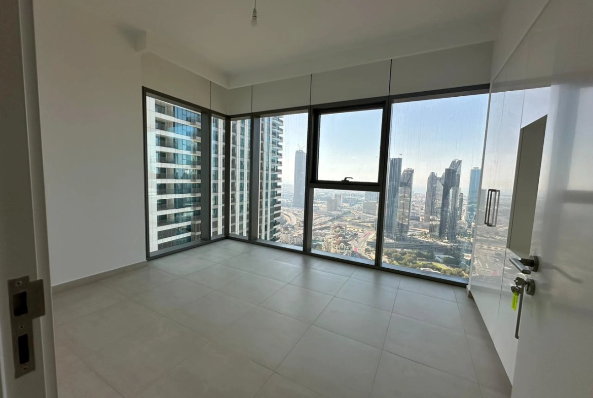 Exterior view of Downtown Views II, a modern apartment complex in Dubai, featuring sleek architectural design with glass facades, and an interior shot of a three-bedroom apartment with contemporary decor, large windows, and luxurious finishes.