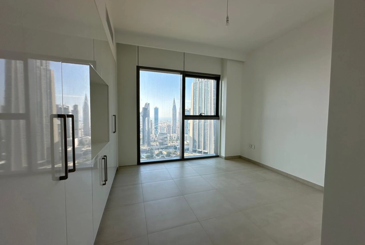 Exterior view of Downtown Views II, a modern apartment complex in Dubai, featuring sleek architectural design with glass facades, and an interior shot of a three-bedroom apartment with contemporary decor, large windows, and luxurious finishes.