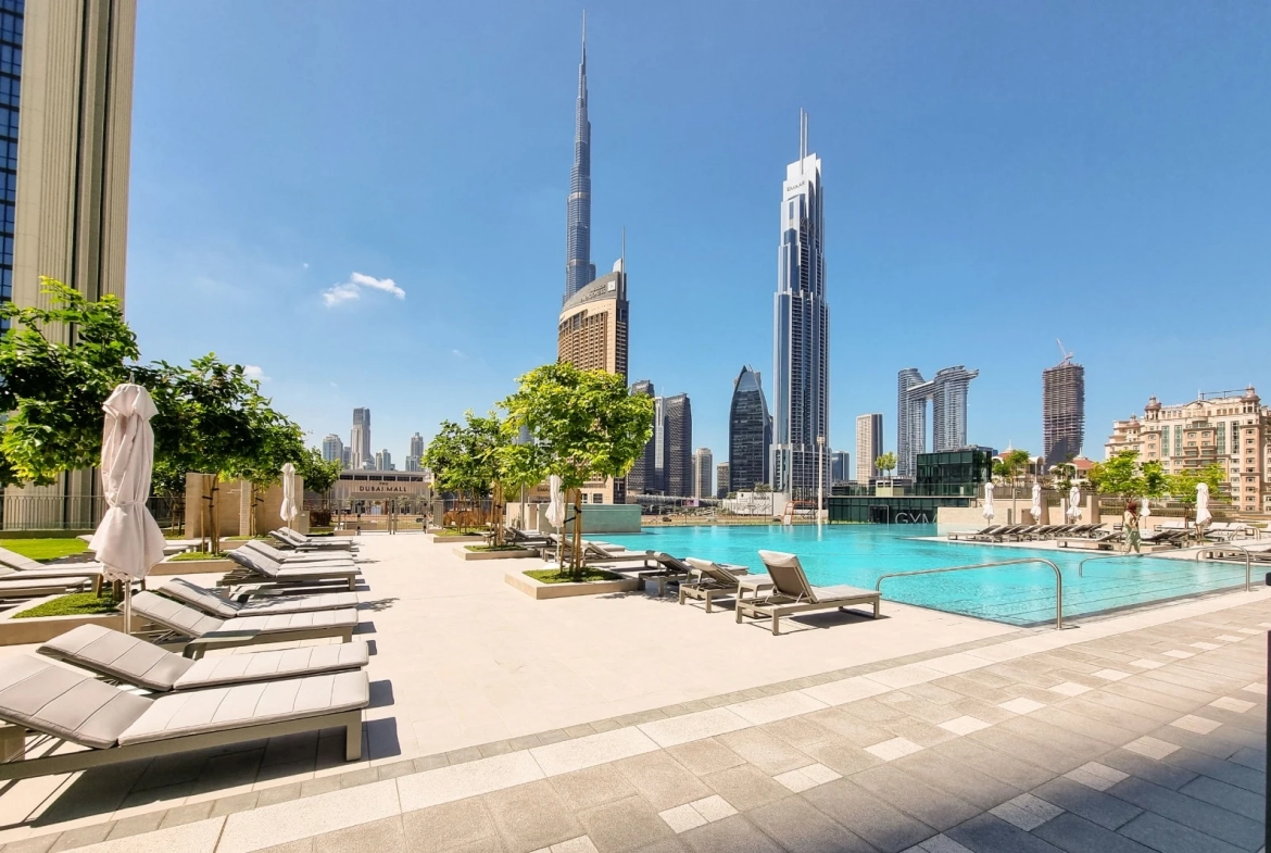 Exterior view of Downtown Views II, a modern apartment complex in Dubai, featuring sleek architectural design with glass facades, and an interior shot of a three-bedroom apartment with contemporary decor, large windows, and luxurious finishes.