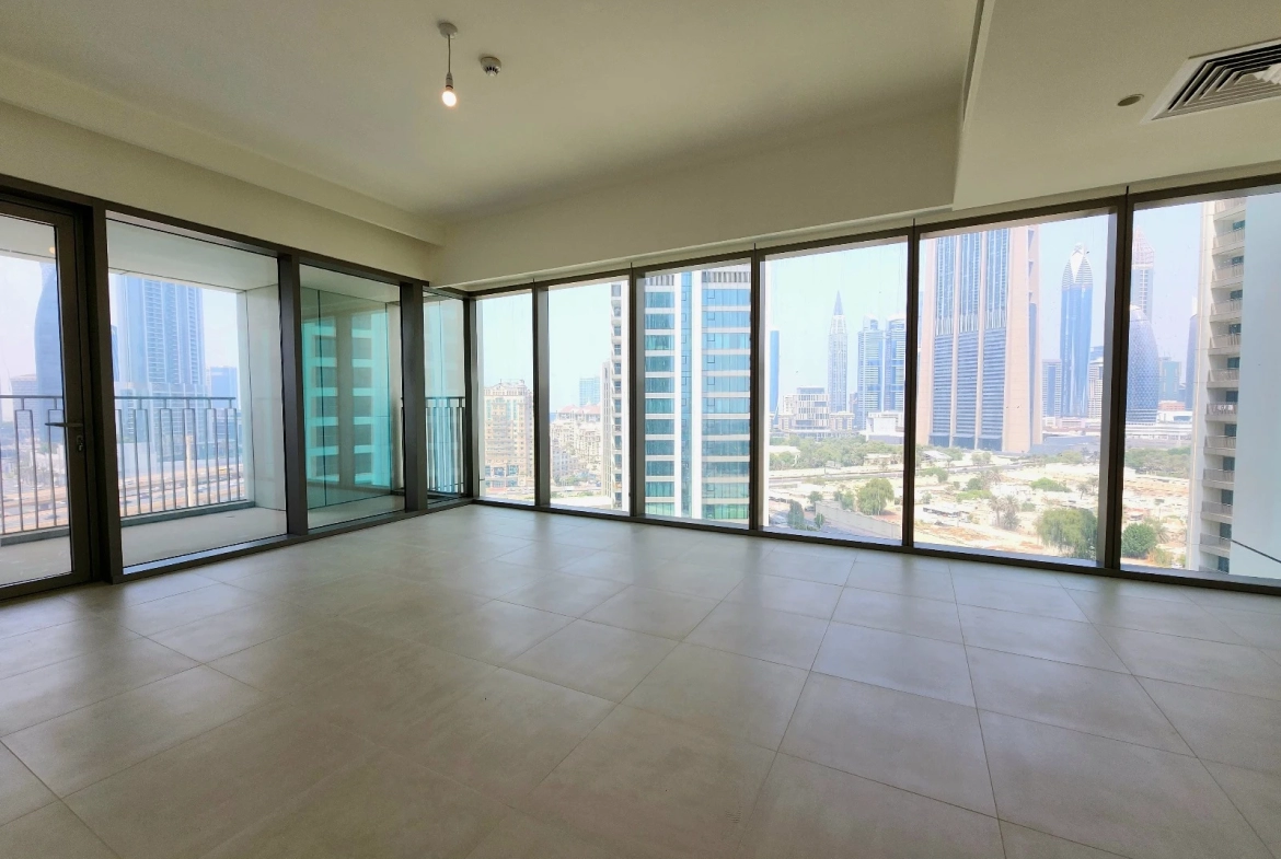 Exterior view of Downtown Views II, a modern apartment complex in Dubai, featuring sleek architectural design with glass facades, and an interior shot of a three-bedroom apartment with contemporary decor, large windows, and luxurious finishes.