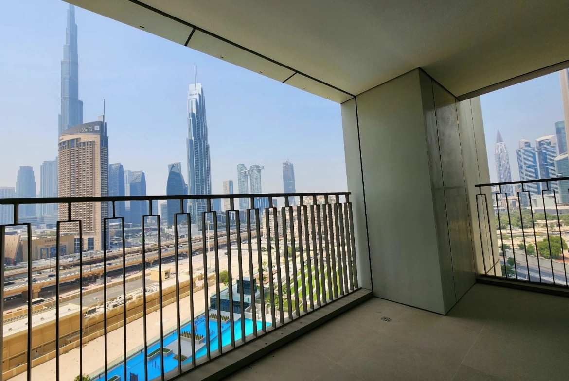 Exterior view of Downtown Views II, a modern apartment complex in Dubai, featuring sleek architectural design with glass facades, and an interior shot of a three-bedroom apartment with contemporary decor, large windows, and luxurious finishes.