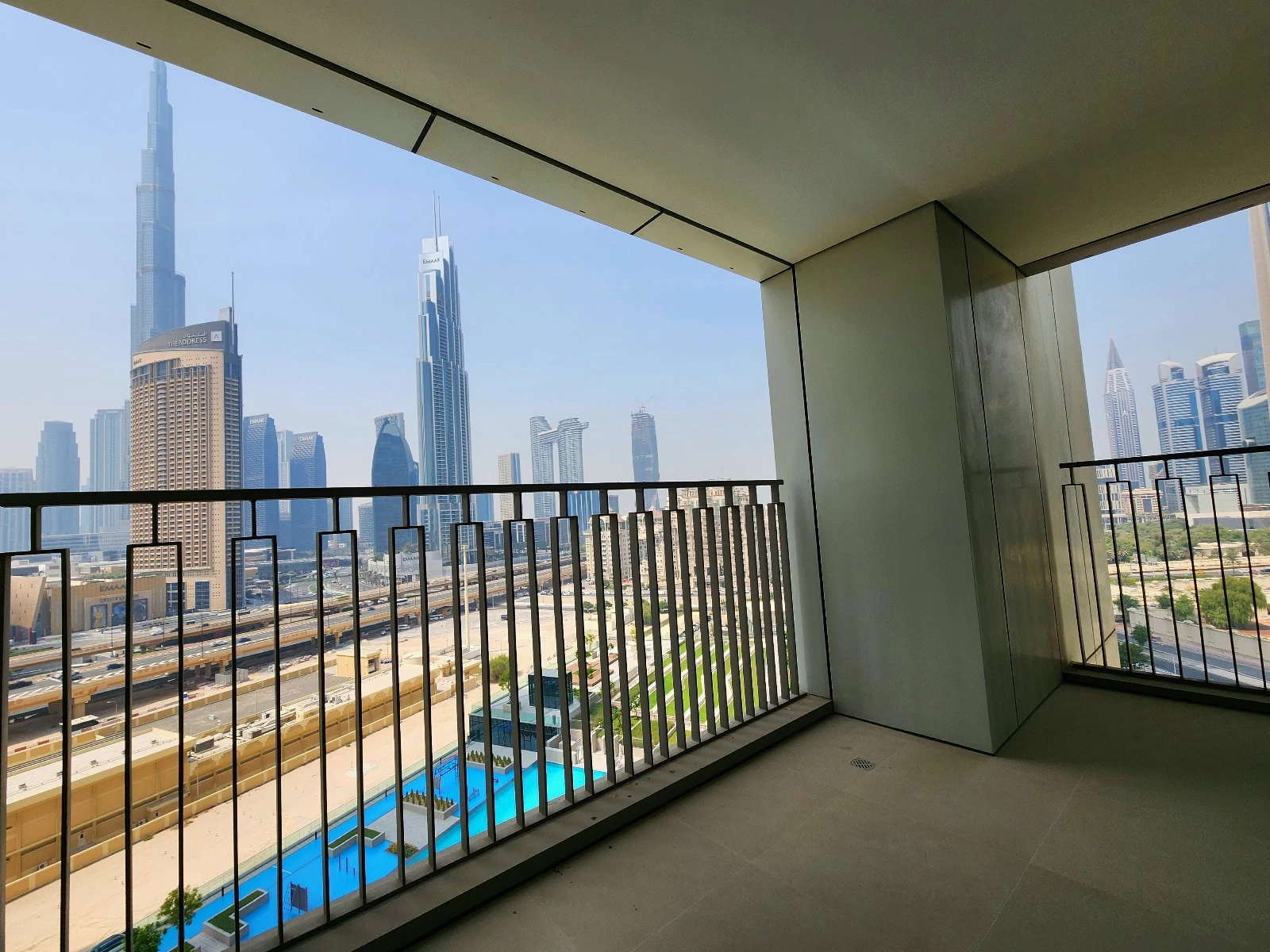 Exterior view of Downtown Views II, a modern apartment complex in Dubai, featuring sleek architectural design with glass facades, and an interior shot of a three-bedroom apartment with contemporary decor, large windows, and luxurious finishes.