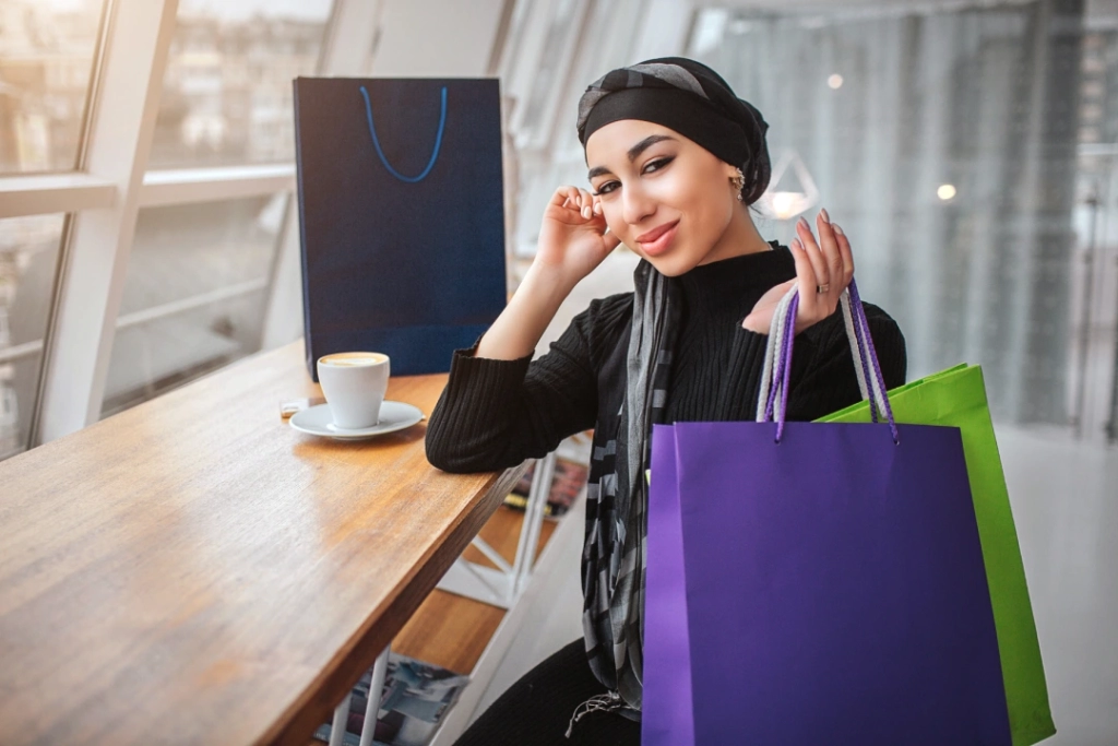 Image of a Woman with shopping bags: "Embrace the convenience of e-commerce amidst Dubai's flourishing retail scene."