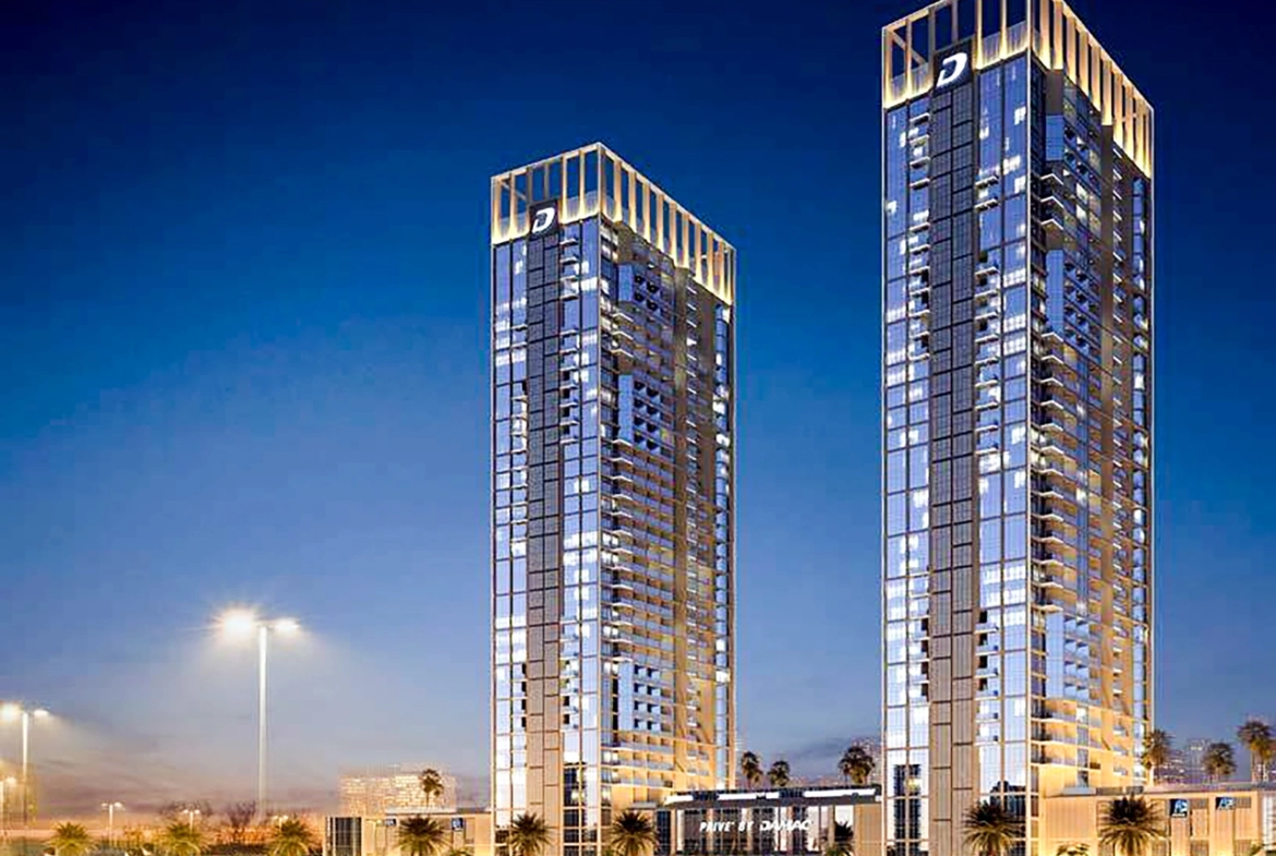 Modern studio apartment interior at Damac Maison Prive in Business Bay, Dubai, showing a well-equipped kitchenette, cozy sleeping area, and living space with large windows overlooking the city.