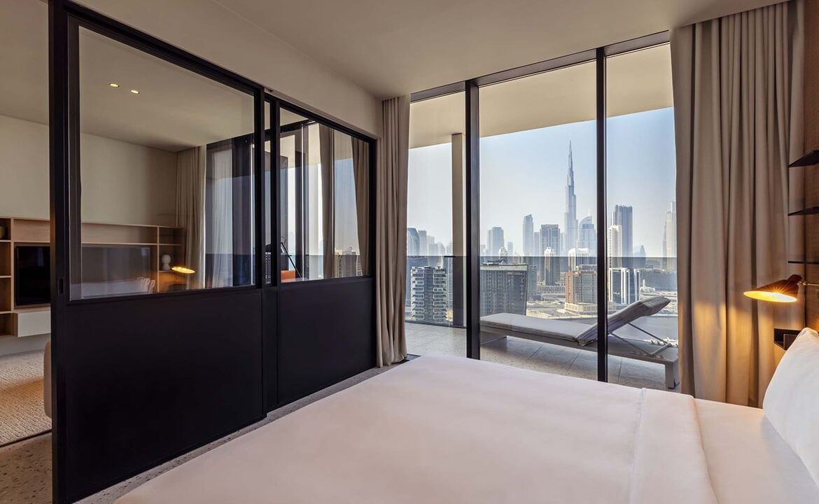 Bed area in the rental studio at Upside Living with a stylish divider, offering a cozy and private space.