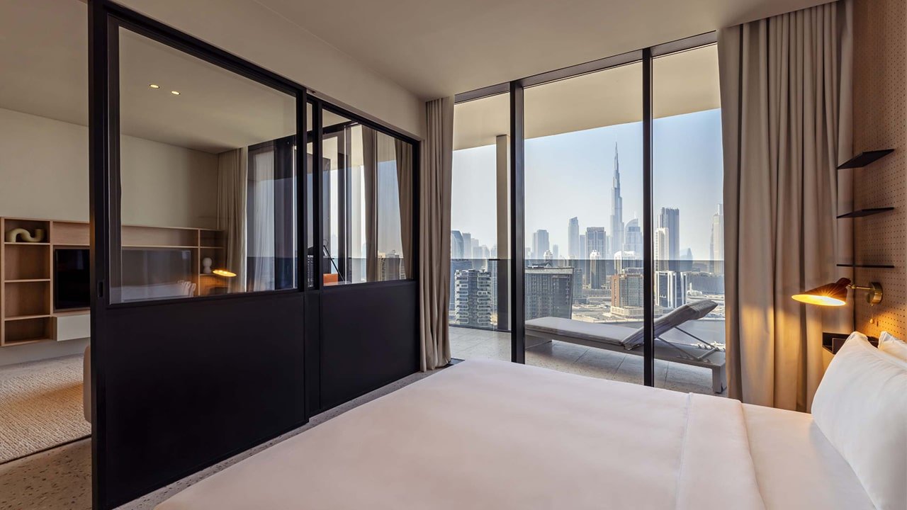 Bed area in the rental studio at Upside Living with a stylish divider, offering a cozy and private space.