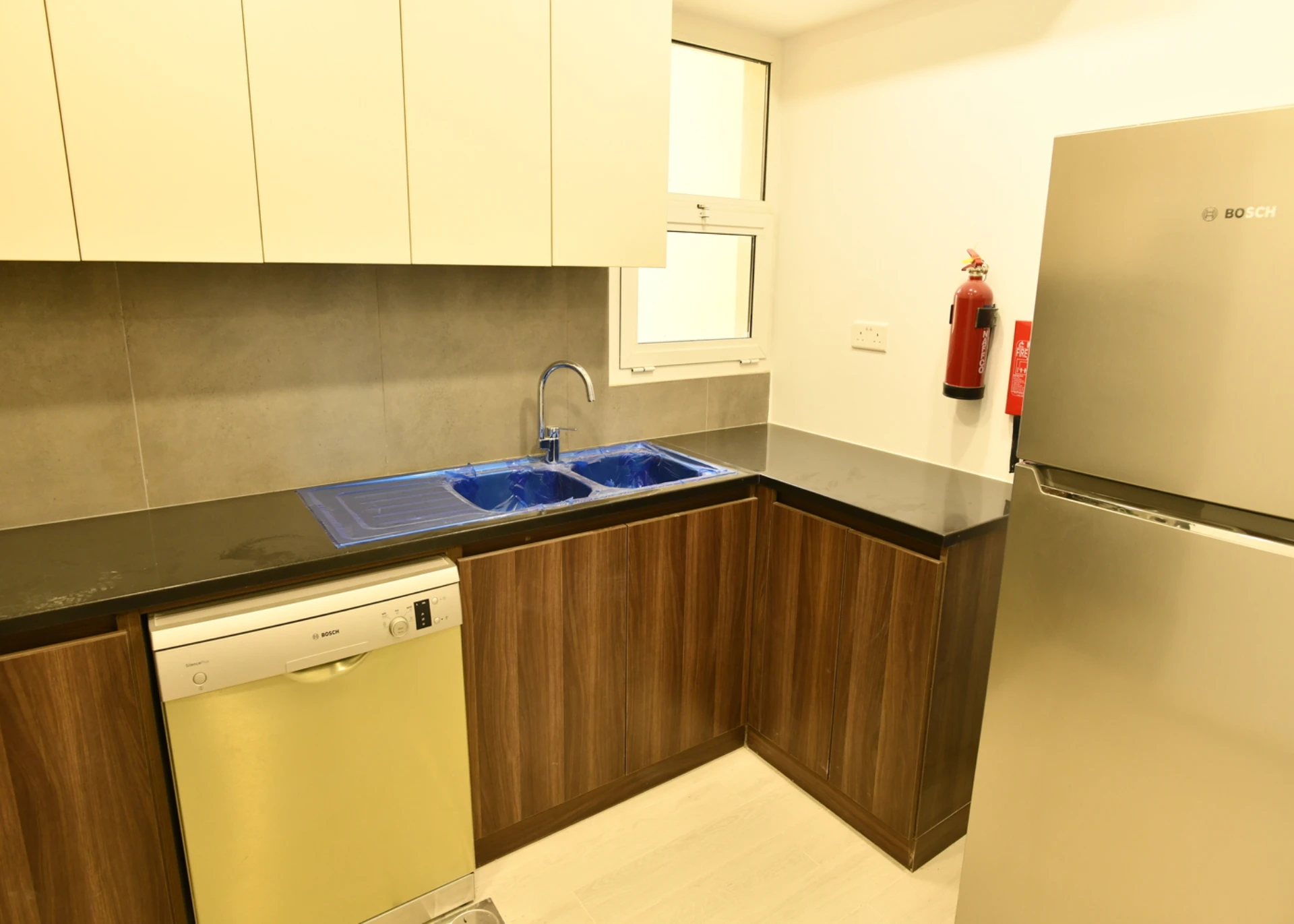 Furnished kitchen in a 2-bedroom apartment for sale in Al Rimth 13, Remraam, Dubai.