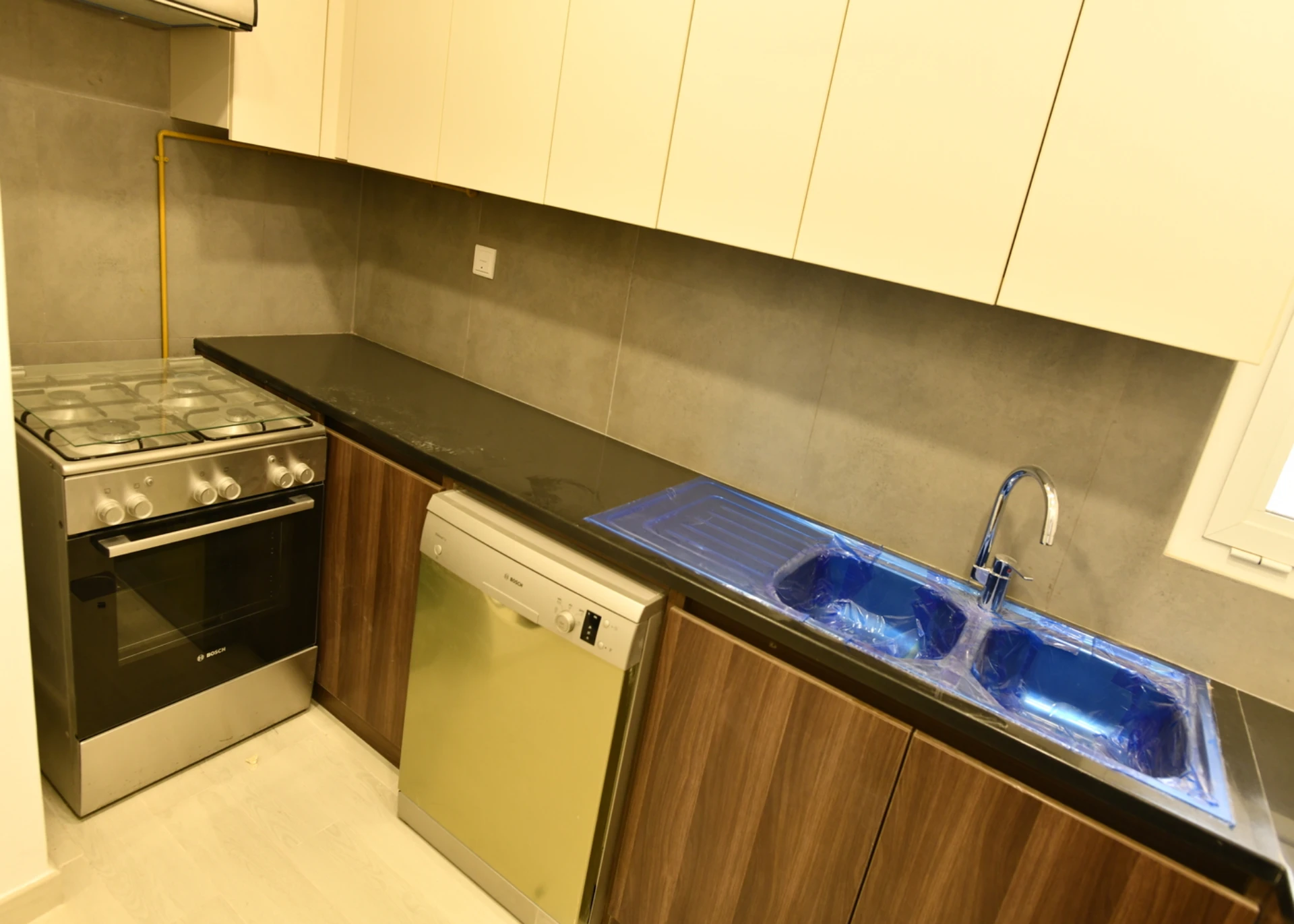 View of the furnished kitchen in a 2-bedroom apartment for sale in Al Rimth 13, Remraam, Dubai.