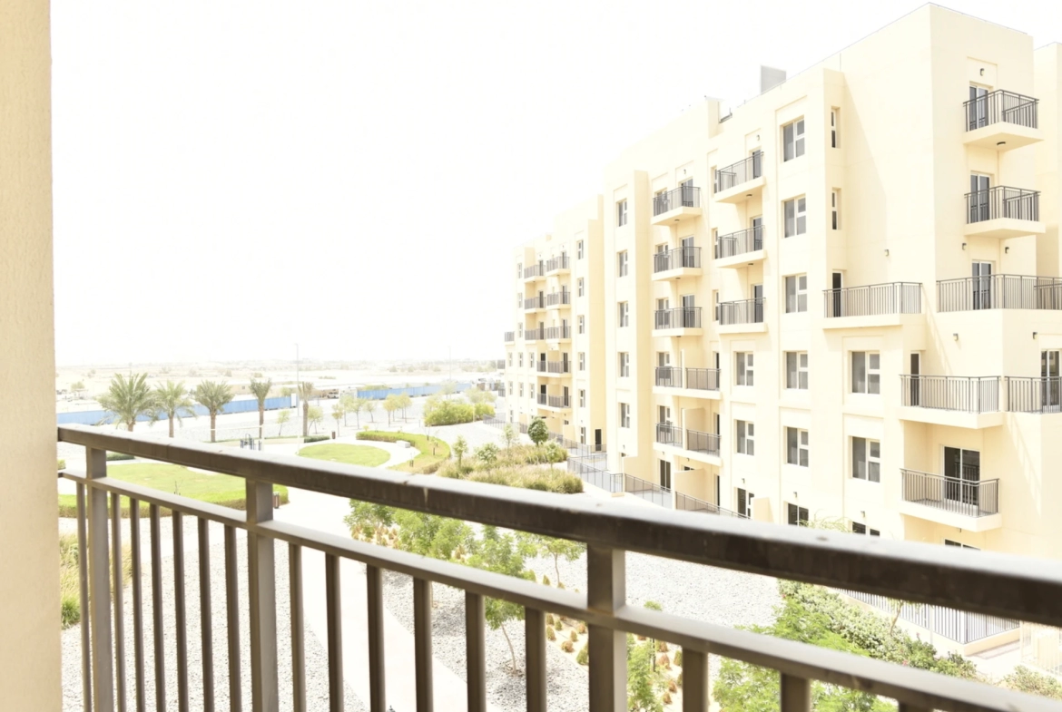 Street view from the balcony of a 2-bedroom apartment for sale in Al Rimth 13, Remraam, Dubai.