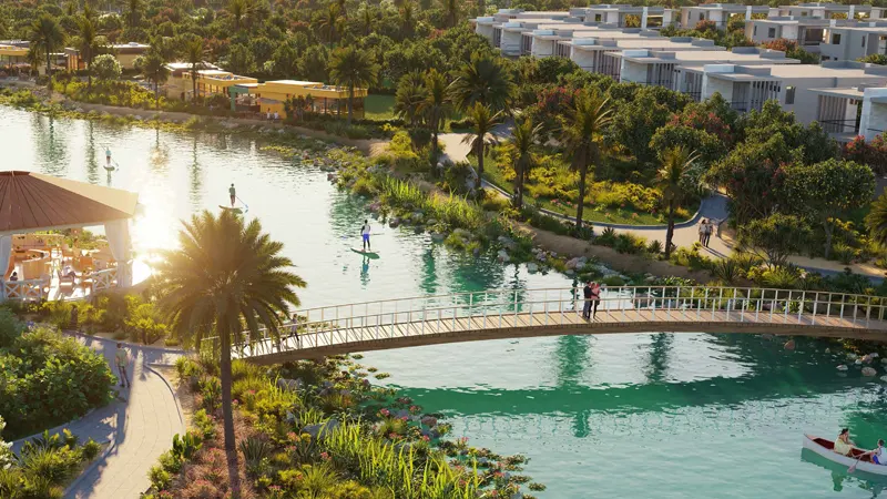 View of the lagoon with a bridge at ELO 3, an off-plan project at Damac Hills 2 by Damac in Dubai.