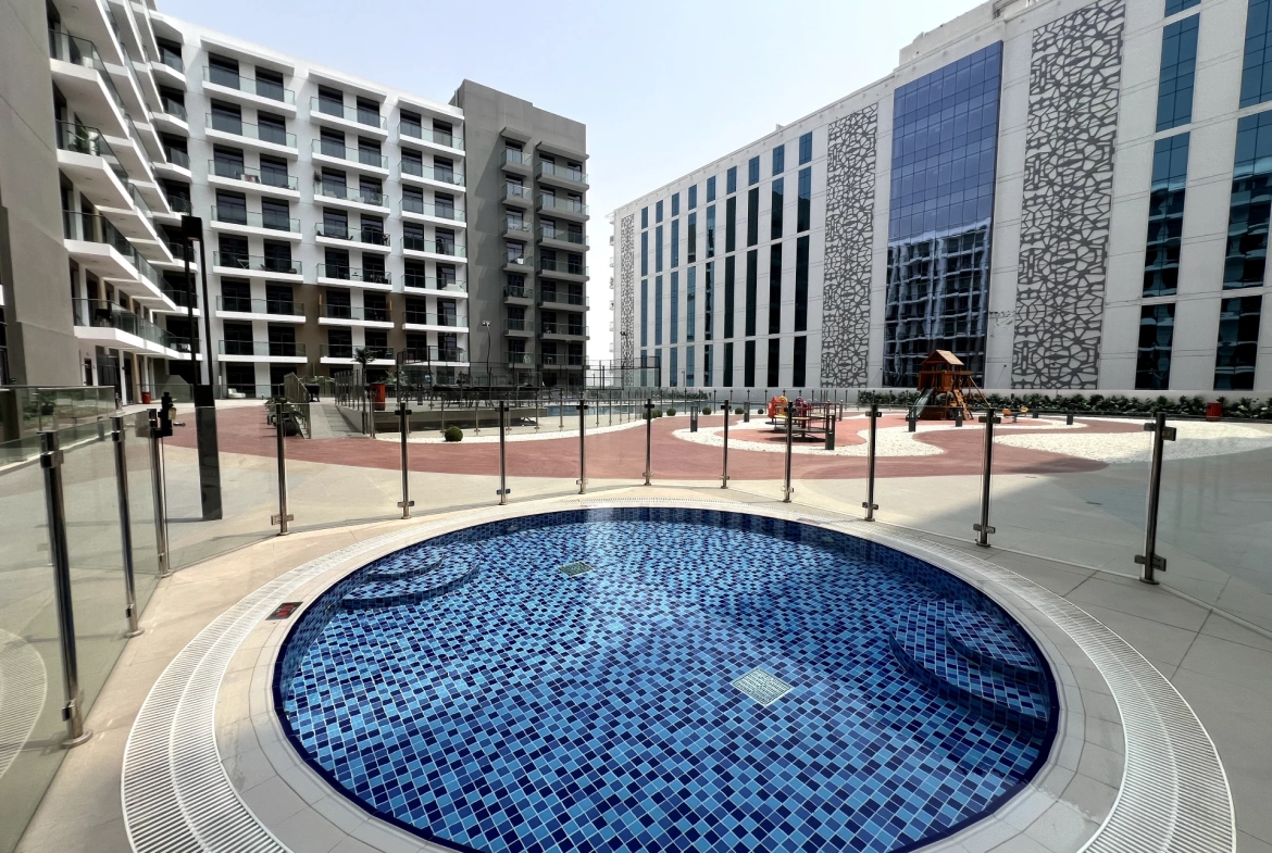 Pool area in Laya Heights, Studio City, Dubai, available for residents.