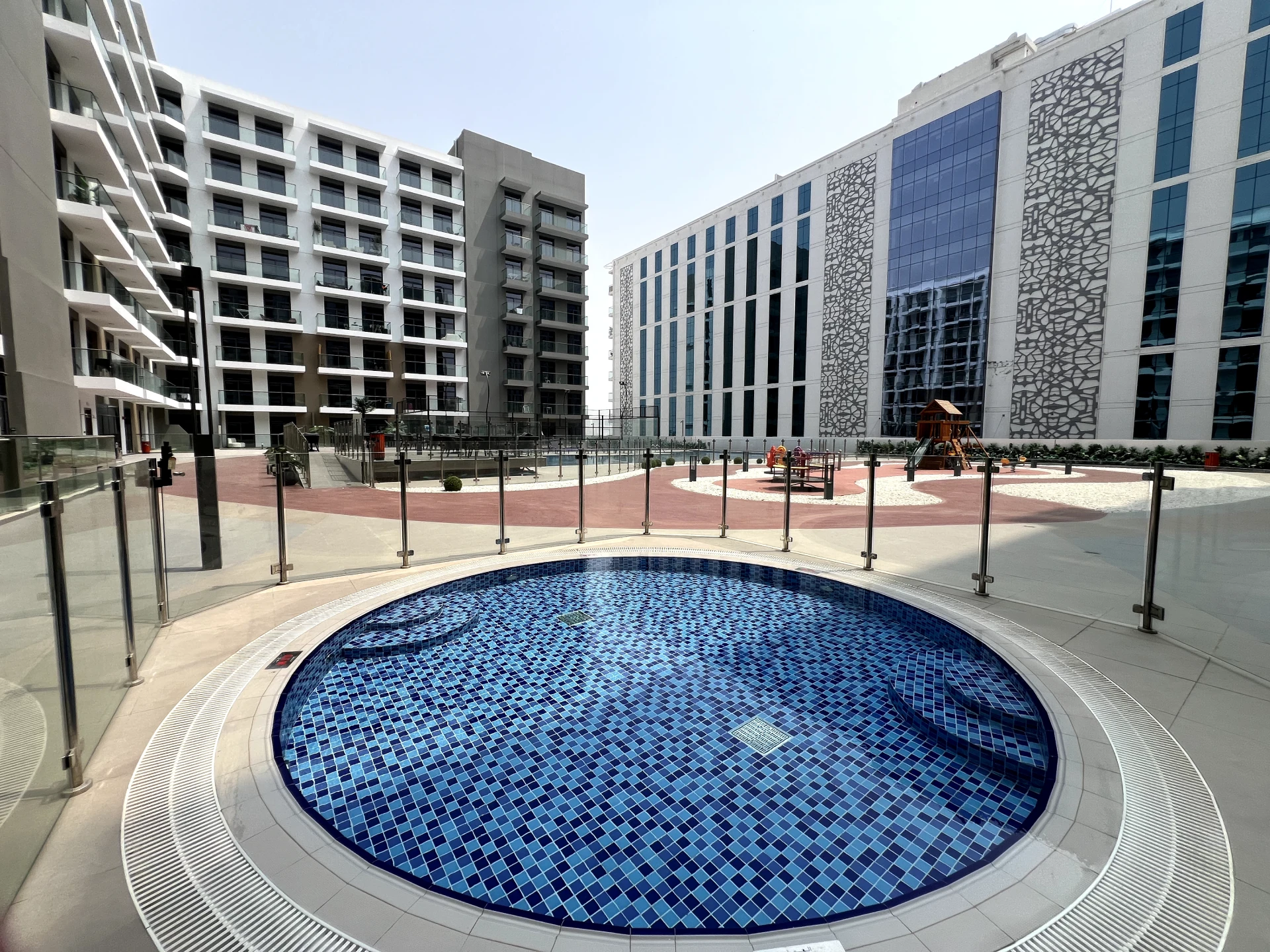 Pool area in Laya Heights, Studio City, Dubai, available for residents.