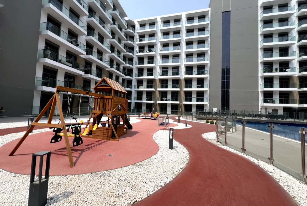 Playground area in Laya Heights, Studio City, Dubai, available for residents