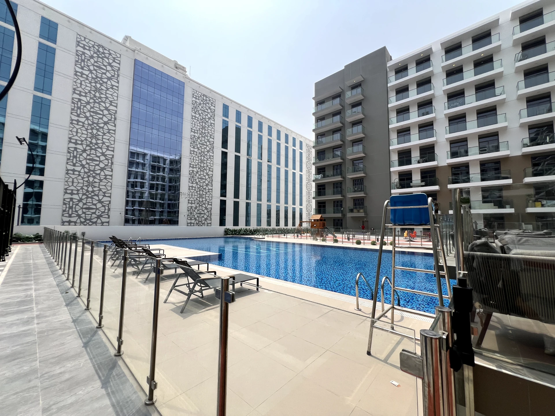 Swimming pool in Laya Heights, Studio City, Dubai, available for residents.